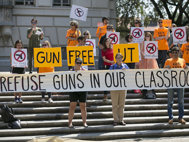 Texas college students wave sex toys to protest  law that allows concealed handguns in classrooms
