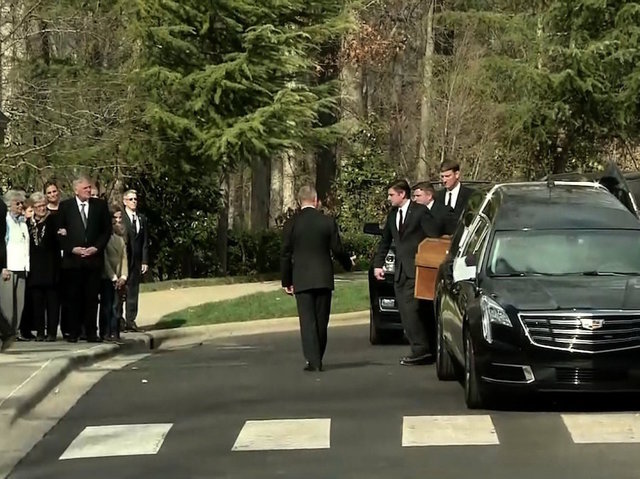 Crowds line up to see Billy Graham's funeral motorcade bring his casket from Asheville to Charlotte
