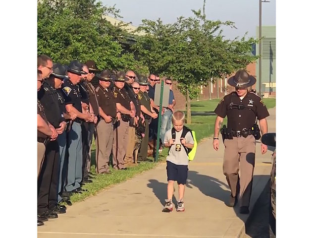 70 cops stood by as son of fallen officer returned to school